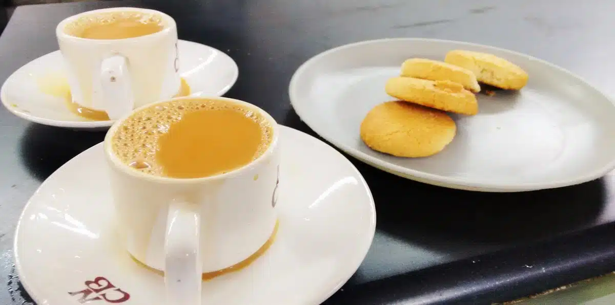 Irani Chai on small round plate and Osmania Biscuits on a plate