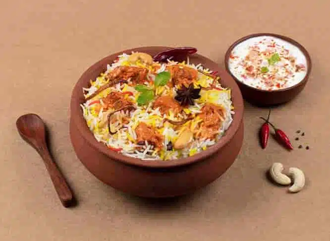 Hyderabad Dum Pukht in a bowl with a spoon and sauce